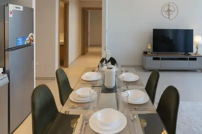 a dining room with a table and chairs and a television at Elegant 2 Bedroom Luxury Living in Harbour Gate - Allsopp&Allsopp in Dubai