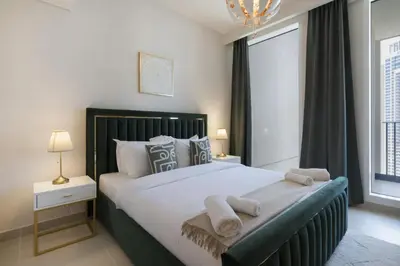 a bedroom with a large bed with two towels on it at Elegant 2 Bedroom Luxury Living in Harbour Gate - Allsopp&Allsopp in Dubai