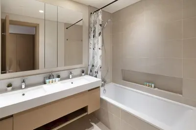 a bathroom with a sink and a tub and a mirror at Elegant 2 Bedroom Luxury Living in Harbour Gate - Allsopp&Allsopp in Dubai