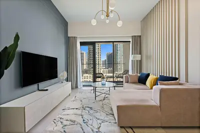 a living room with a flat screen tv and a couch at Silkhaus Burj Royale 1BDR with balcony in Downtown in Dubai