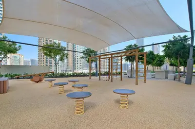a group of tables and stools in a playground at Silkhaus Burj Royale 1BDR with balcony in Downtown in Dubai
