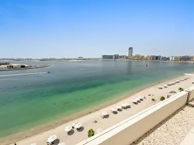 an aerial view of a beach with umbrellas and the ocean at Seaside Serenity: 1-BR Apartment with Beach Access in Dubai