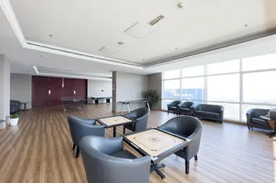 a waiting room with chairs and tables and windows at GuestReady - Lux interiors in Dubai Marina in Dubai