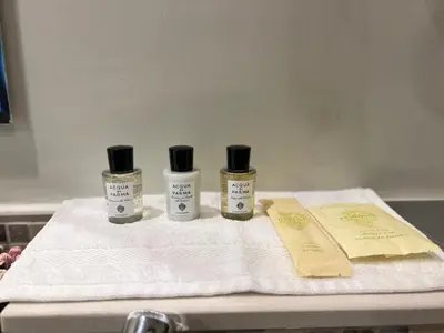 three bottles of essential oils sitting on top of a towel at Athesa Apartments Downtown Dubai Business Bay in Dubai