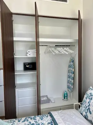 a bedroom with a bed and a closet at Athesa Apartments Downtown Dubai Business Bay in Dubai