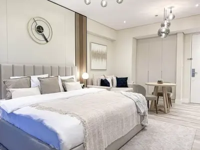 a bedroom with a large bed and a table at Breathtaking view studio – Address Dubai Marina in Dubai