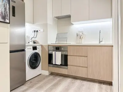 a kitchen with a washing machine and a washer at Breathtaking view studio – Address Dubai Marina in Dubai