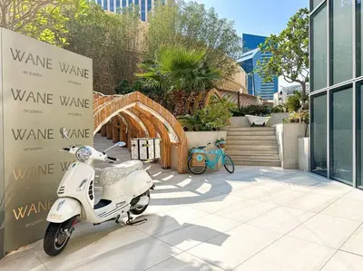 a white scooter parked in front of a building at Breathtaking view studio – Address Dubai Marina in Dubai