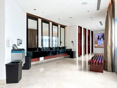a lobby with a waiting area with benches and windows at Breathtaking view studio – Address Dubai Marina in Dubai