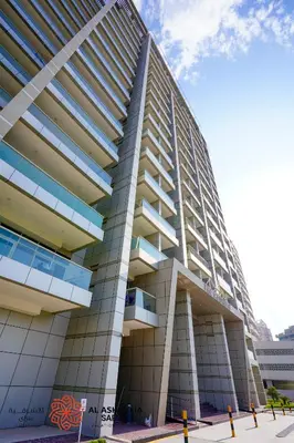 a tall building with balconies on the side of it at Alashrafia Saray - Adorable 1BR in Sports City in Dubai