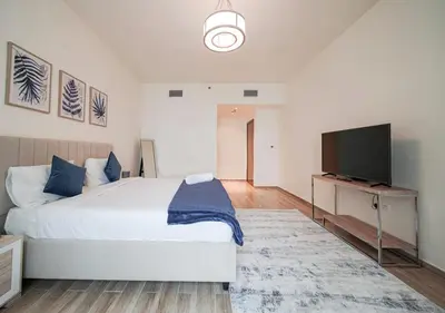 a bedroom with a bed and a flat screen tv at The stylish Meera tower 3606 apartment in Al Habtoor city in Dubai