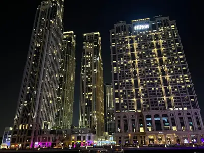 a group of tall buildings lit up at night at The stylish Meera tower 3606 apartment in Al Habtoor city in Dubai