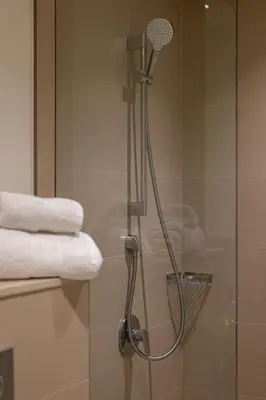a shower in a bathroom with some towels at TH-Homes Downtown 2 Bedroom with Burj Khalifa view in Dubai