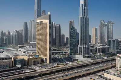 a city with many tall buildings and a highway at TH-Homes Downtown 2 Bedroom with Burj Khalifa view in Dubai