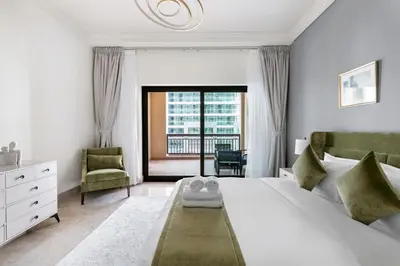 a bedroom with a large white bed and a window at StoneTree - Fairmont North 2 BR - Beach Access in Dubai