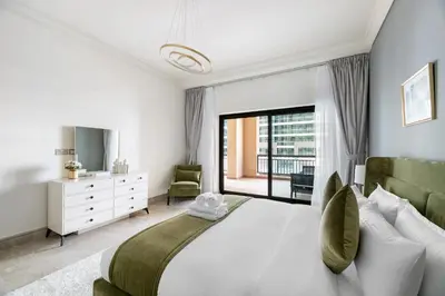 a bedroom with a large bed and a large window at StoneTree - Fairmont North 2 BR - Beach Access in Dubai