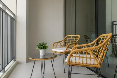 a group of chairs and a table on a balcony at Creek View Apartment in Creek Harbour in Dubai