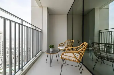 a balcony with two chairs and a table on it at Creek View Apartment in Creek Harbour in Dubai