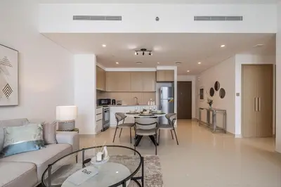 a living room with a couch and a table at Creek View Apartment in Creek Harbour in Dubai