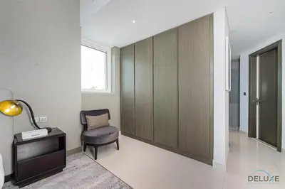 a room with a chair and a desk and a window at Special Offer Elegant Studio with Iconic Canal Views by Deluxe Holiday Homes in Dubai