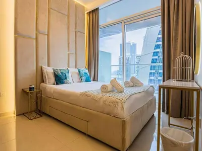a hotel room with a bed with a large window at TURQUOISE - Downtown Dubai 1 BEDROOM APARTMENT Business Bay - CANAL VIEW in Dubai