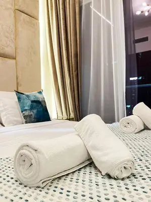 a hotel room with a bed with towels on it at TURQUOISE - Downtown Dubai 1 BEDROOM APARTMENT Business Bay - CANAL VIEW in Dubai