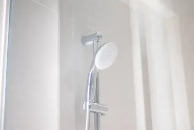 a shower with a shower head in a bathroom at Upscale 1 bed apartment in Business Bay-Suiteable in Dubai