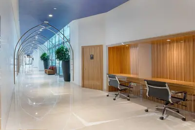 a lobby with desks and chairs in a building at Upscale 1 bed apartment in Business Bay-Suiteable in Dubai