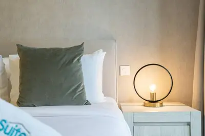 a bedroom with a bed with a mirror on a table at Lush Tropical Getaway in Dubai Marina in Dubai