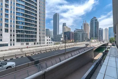 a highway in a city with tall buildings at Lush Tropical Getaway in Dubai Marina in Dubai