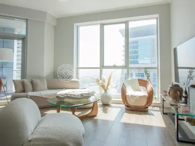 a living room with a couch and a table at Birds Eye 2BR - Torch Tower-L51 - Near Marina Walk in Dubai