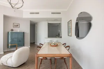 a dining room with a table and chairs and a chalkboard at Birds Eye 2BR - Torch Tower-L51 - Near Marina Walk in Dubai