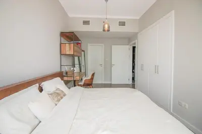 a bedroom with a large white bed and a desk at Birds Eye 2BR - Torch Tower-L51 - Near Marina Walk in Dubai