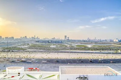 a view of a parking lot with a beach and a city at Picturesque Studio at Carson A DAMAC Hills Dubailand by Deluxe Holiday Homes in Dubai