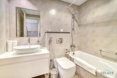 a bathroom with a sink and a tub and a toilet at Picturesque Studio at Carson A DAMAC Hills Dubailand by Deluxe Holiday Homes in Dubai