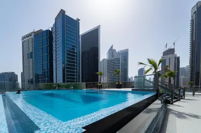 a large swimming pool in a city with tall buildings at Romantic hideaway w breathtaking Burj Khalifa view in Dubai