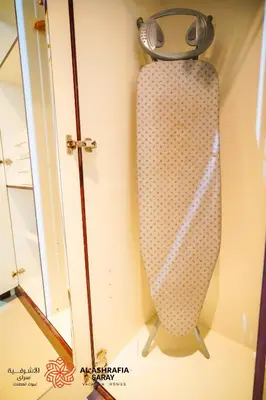 a skateboard on a wall with a watch on it at Alashrafia Saray - Wonderful 1BR in Sports City in Dubai