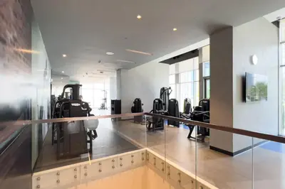 a gym with treadmills and elliptical machines at GuestReady - Luxury 1BR | Skyline & Canal View in Dubai