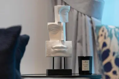a statue of a head on a stand on a table at Modern Brand New 1BR Holiday Homes at Greens in Dubai