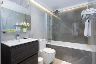 a bathroom with a toilet and a sink and a shower at Modern Brand New 1BR Holiday Homes at Greens in Dubai