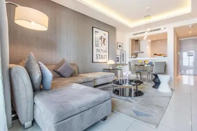 a living room with a couch and a table at Damac Towers By Paramount Apartments - The S Holiday Homes in Dubai
