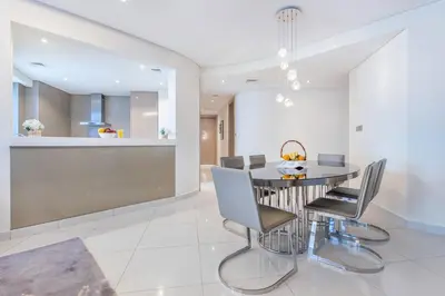 a dining room with a table and chairs at Damac Towers By Paramount Apartments - The S Holiday Homes in Dubai