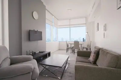 a living room with two couches and a table at StoneTree - Botanica Tower 1 BR - Close to Beach in Dubai