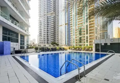 a large swimming pool in a building with tall buildings at StoneTree - Botanica Tower 1 BR - Close to Beach in Dubai