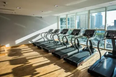 a row of treadmills in a gym with windows at StoneTree - Botanica Tower 1 BR - Close to Beach in Dubai