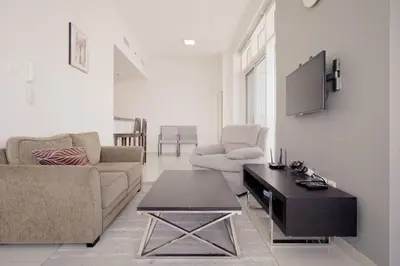 a living room with a couch and a table at StoneTree - Botanica Tower 1 BR - Close to Beach in Dubai