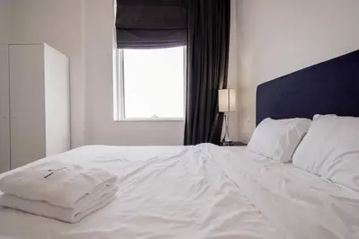 a white bed in a bedroom with a window at StoneTree - Botanica Tower 1 BR - Close to Beach in Dubai