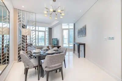 a dining room with a table and chairs at Sophisticated Business Bay Canal View by Suiteable in Dubai