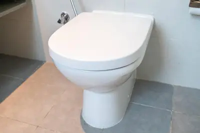 a white toilet sitting in a bathroom at Sophisticated Business Bay Canal View by Suiteable in Dubai
