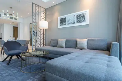 a living room with a couch and a table at Sophisticated Business Bay Canal View by Suiteable in Dubai